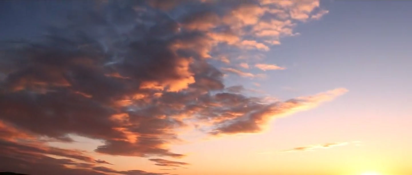 Dawn clouds drifting over a first-light sky